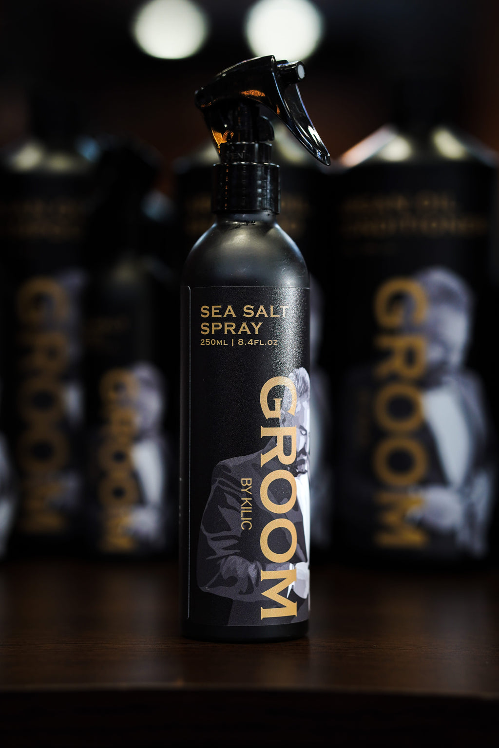 Sea salt spray bottle labeled 'Groom' with a blurred background